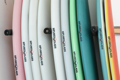 Surfboard picture of in stock surfboards on a surfboard rack. Akila Aipa, Channel Islands Surfboards, Maurice Cole, Surf Prescriptions, Lovelace Surfcreaft, Xanadu all with different surfboard art airbrushes 